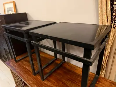 Pair of black square side tables with glass tops