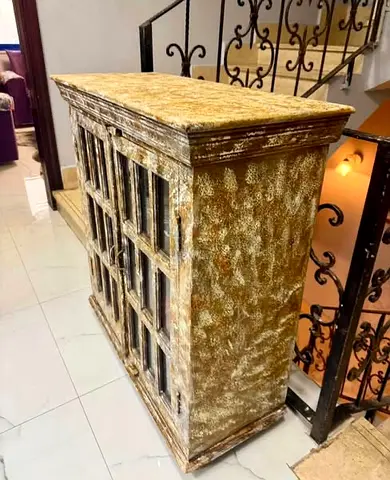 Vintage distressed wooden cabinet with glass paneled doors