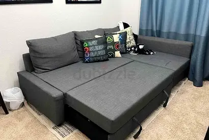 Grey L-shaped convertible sofa bed — good condition