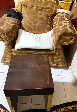Single cushioned armchair with wooden coffee table - used