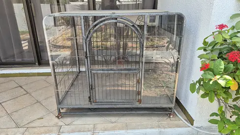 Large metal cage on wheels with built in AC - good condition