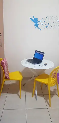 Small round dining table with two yellow chairs - compact set