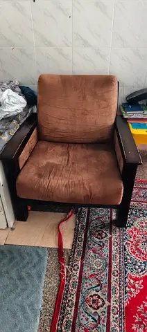 Brown cushioned wooden armchair - used