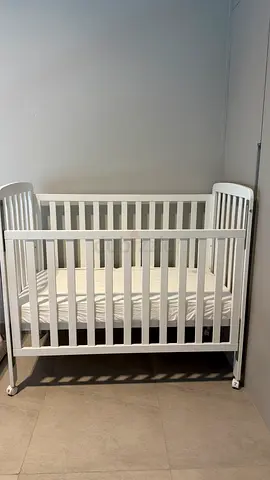 Unused Mothercare Drop Side Cot with Wheels