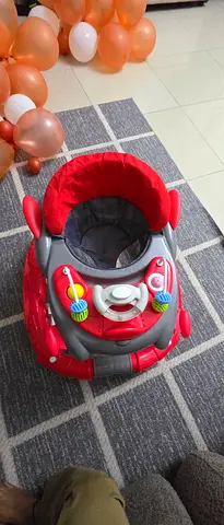 Red adjustable baby walker/rocker in good condition