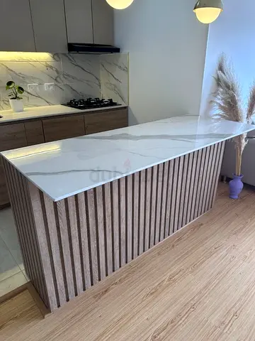 Modern kitchen island with marble top and wooden slat base