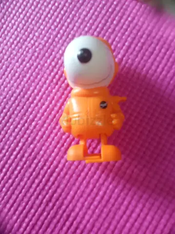 Small orange cyclops astronaut toy figure - loose