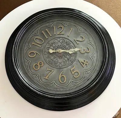 Vintage-style round wall clock with ornate face (used)