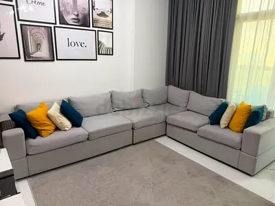 Light grey L-shaped sectional sofa with cushions - excellent condition