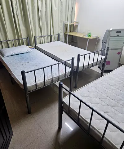 Pair of single metal bed frames with mattresses