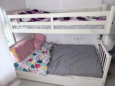 White wooden bunk bed with guardrails — good condition