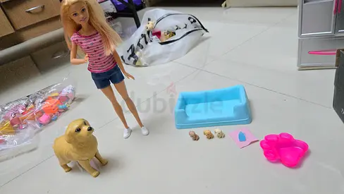 Mattel Barbie Newborn Pups playset featuring a doll with a mommy dog and three puppies.