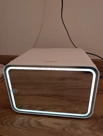 portable mini beauty fridge designed for storing cosmetics and skincare products, likely featuring a