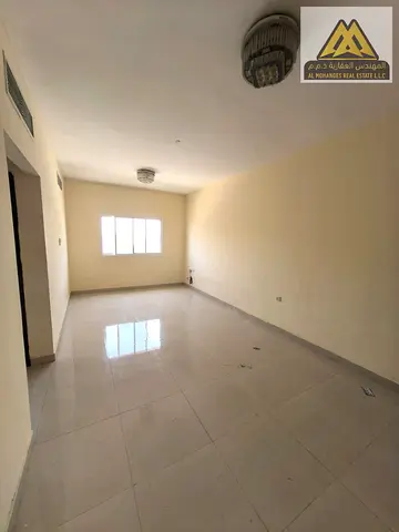 A spacious two-bedroom apartment is available for annual rent in Al Rawda 1, Ajman. The apartment features a practical layout, two bathrooms, a beauti