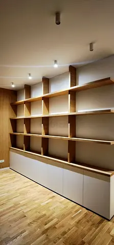 Custom built-in wooden shelving unit with lower cabinets - good condition