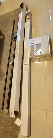 Set of new curtain rods and accessories (unopened/boxed)