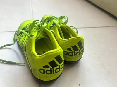 Used Adidas neon green indoor turf football shoes, size US3