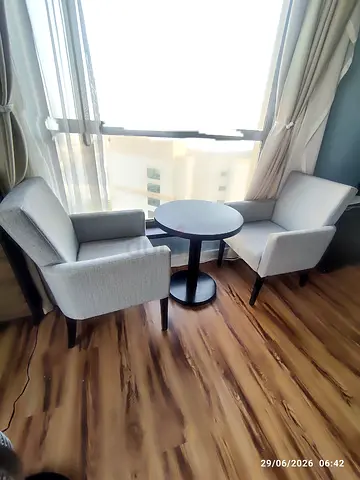 Pair of modern grey lounge chairs with small round side table