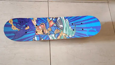 Used colorful kids skateboard deck with cartoon graphics - good condition