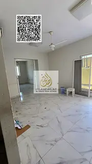 Two-bedroom apartment with a living room, majlis (formal sitting room), roof terrace, and storage ro