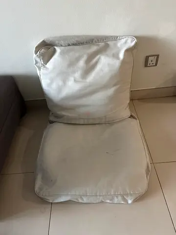 Single beige lounge chair with removable cushion — used
