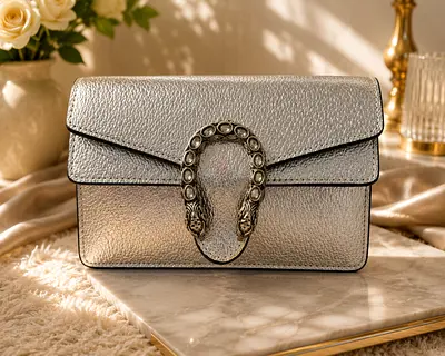 Silver leather crossbody bag with embellished horseshoe clasp