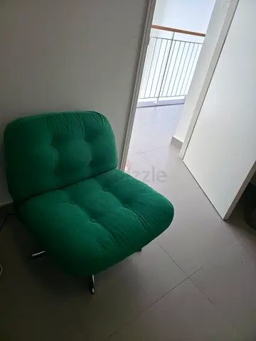 Green armless lounge chair in good condition