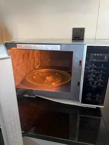 Panasonic microwave oven 25L along with microwave safe bowls and plates