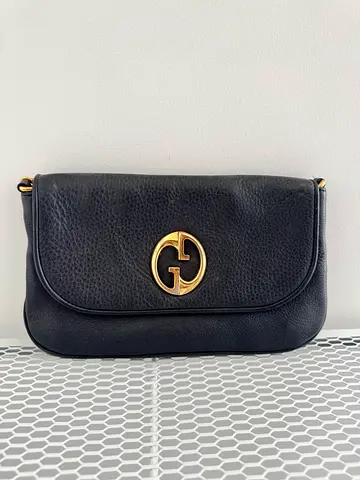Vintage 1973 Gucci Black leather crossbody bag with gold logo and chain - compact handbag