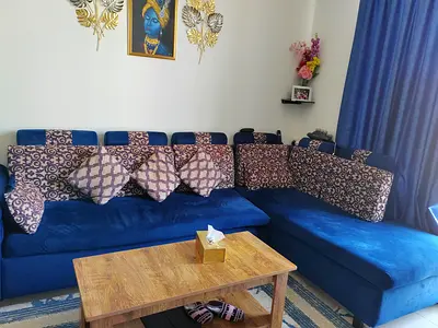 Blue L-shaped Fabric Sofa with Cushions - Good Condition