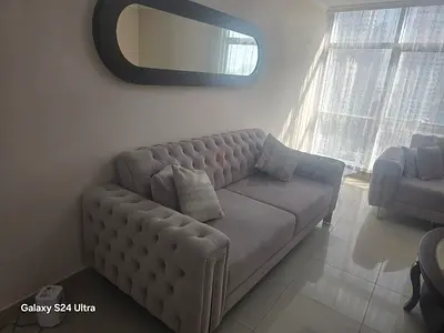 Light grey tufted 3-seater sofa in excellent condition