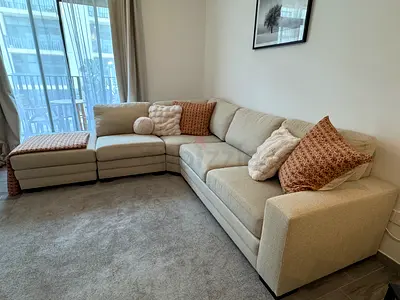 Large L-shaped Beige Fabric Corner Sofa with Ottoman - 5.6m