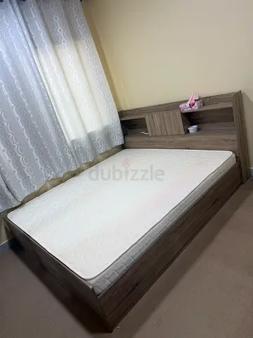 Queen bed frame with mattress and bedside storage - good condition