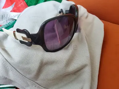 Used womens designer-style sunglasses - purple lenses