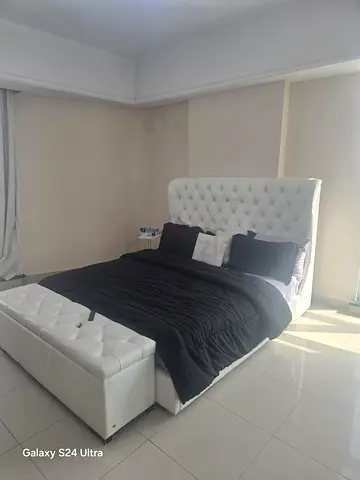 White tufted king-size bed with storage bench - good condition