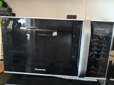 Panasonic microwave oven 25L along with microwave safe bowls and plates