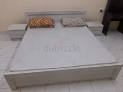 White wooden double bed with two matching nightstands