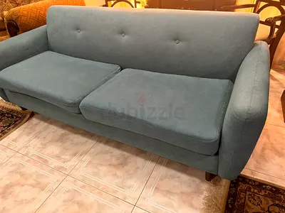 Two-seater teal fabric sofa in good condition