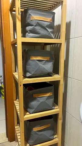 IKEA-style 4-tier wooden shelving unit with fabric storage bins