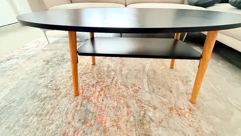 Oval mid-century modern coffee table with lower shelf (black top, oak legs)