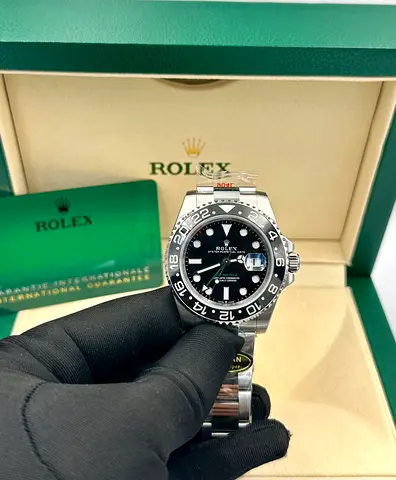 Rolex GMT-Master II, identified by its distinctive black dial and 24-hour GMT hand
