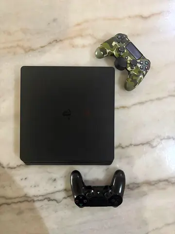 PlayStation 4 Slim with two DualShock 4 controllers (working)