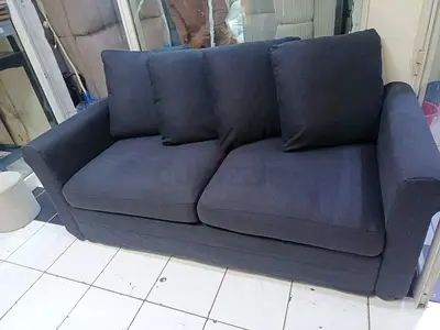 Dark grey 2-seater fabric sofa bed in good condition