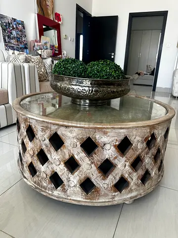 Round rustic wooden coffee table with glass top