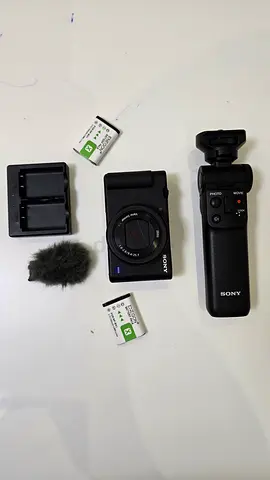 Sony ZV1 series compact camera with accessories (batteries, charger, mic  grip with controls on it)