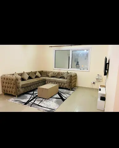 L-shaped tufted velvet sectional sofa with cushions and coffee table