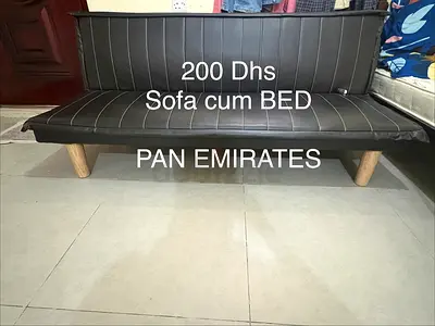 Black faux-leather futon sofa bed + black coffee table - used, good condition