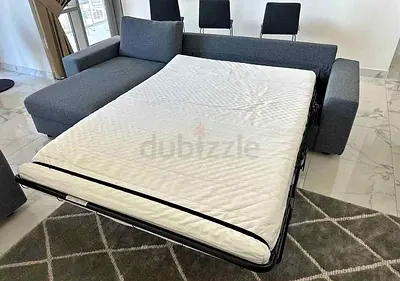 Grey L-shaped Sofa with Pull-Out Bed - Good Condition