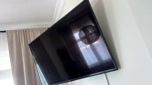 Sony 55-inch LED TV mounted on wall - 2 months old
