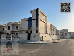 Villa for sale in Ajman, Al Helio area. 5 master bedrooms, majlis, 2 living rooms, maid's room, and 